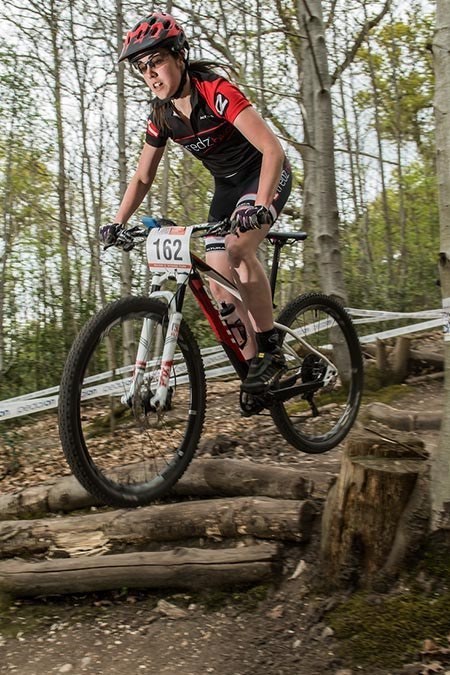 Alex clears a jump in the forest up Afan Argoed